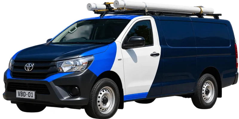 A licensed Northbridge plumbing van loaded with pipe on the roof rack